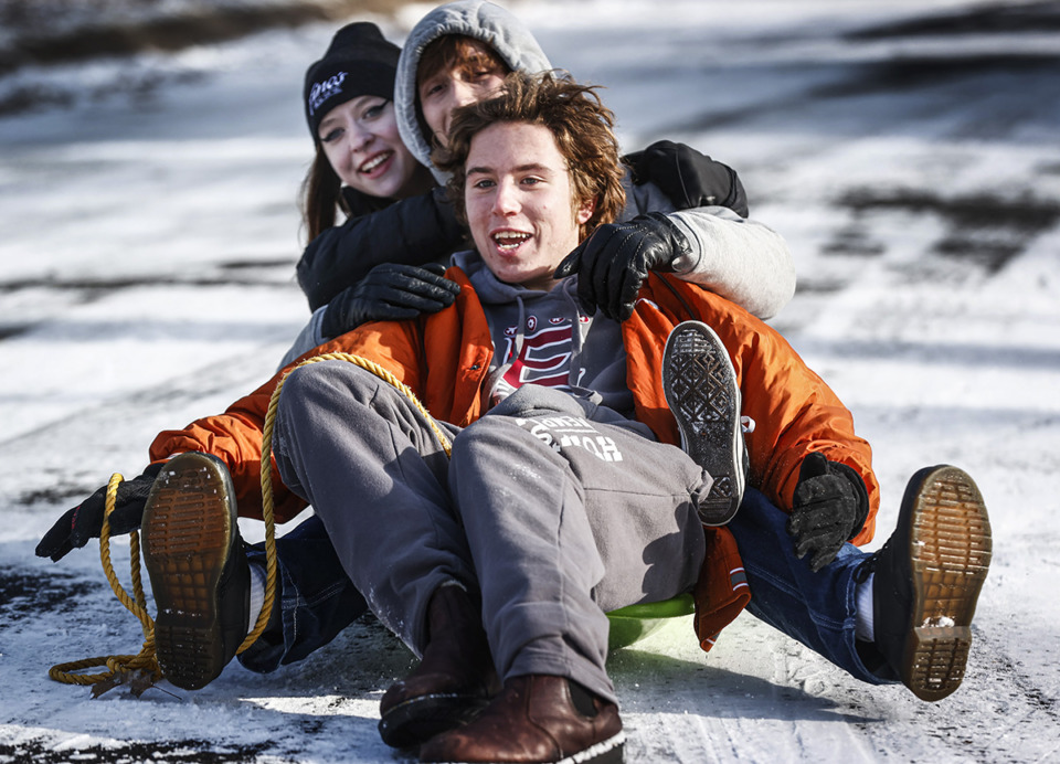 <strong>Brock Weaver, front guides his friends Cannon Haney, middle, and Ayden Couch-Smith while sliding down an icy street in Overton Park on Dec. 23, 2022.</strong> (Mark Weber/The Daily Memphian)