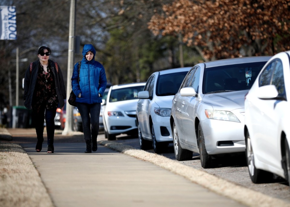<strong>Breanne Hager and Marisa Manuel (right), graduate students in the University of Memphis' creative writing program, walk down Midland Avenue in 2019.</strong> (Houston Cofield/Daily Memphian file)