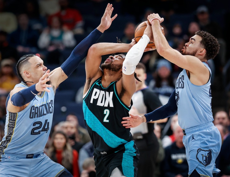 <strong>Memphis Grizzlies defender Dillon Brooks (left) and Tyus Jones (right) apply defensive pressure to Portland Trail Blazers guard Trendon Watford (middle) during action on Wednesday, Feb. 1, 2023.</strong> (Mark Weber/The Daily Memphian)