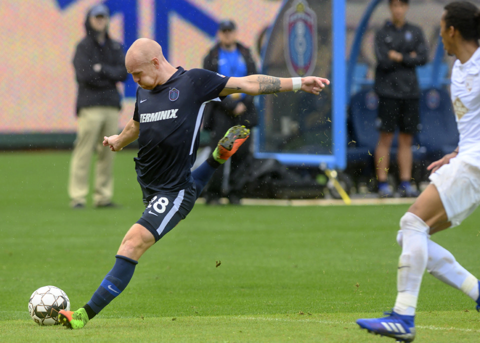 <strong>Jochen Graf forward for the Memphis 901 FC kicks past Birmingham Legion midfielder Zachary Herivaux during the rain-soaked match Saturday, May 4, 2019, at AutoZone Park.</strong> (Greg Campbell/Special to The Daily Memphian)