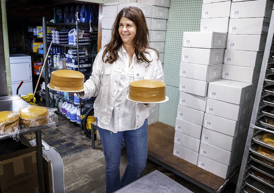 <strong>Sugaree's Bakery&rsquo;s owner Mary Jennifer Russell grabs caramel cakes that her mother makes for her New Albany store.</strong> (Mark Weber/The Daily Memphian)