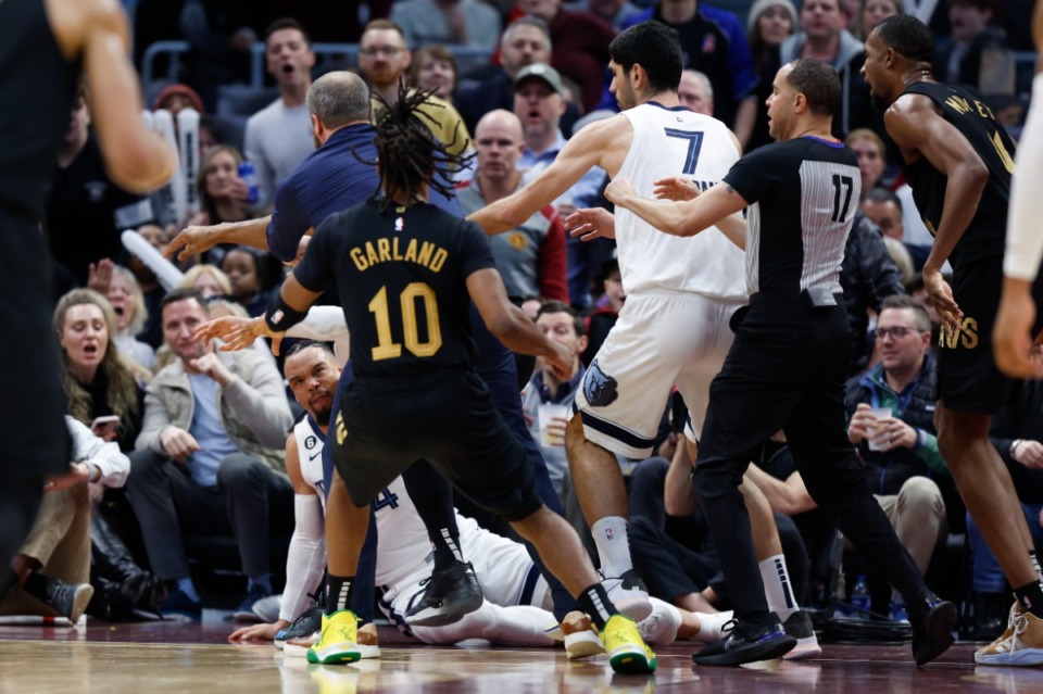 <strong>Memphis Grizzlies forward Dillon Brooks lies on the ground during a fight with Cleveland Cavaliers guard Donovan Mitchell (45) during the second half of an NBA basketball game, Thursday, Feb. 2, 2023, in Cleveland. Mitchell and Brooks were ejected from the game.</strong> (Ron Schwane/AP)