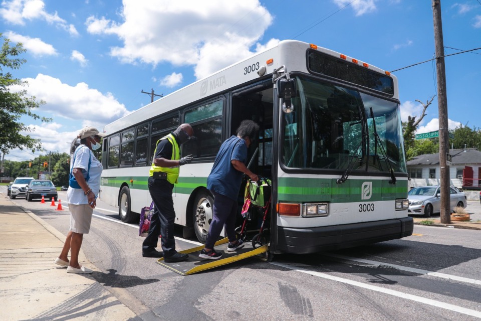 <strong>A MATA worker helps a passenger board a bus in 2022.</strong> (Patrick Lantrip/The Daily Memphian file)