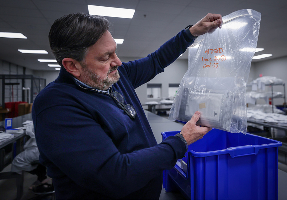 <strong>Brad Kilgore, CEO and owner of DPX, holds up a sample of fascia tissue that is ready for shipping.</strong> (Patrick Lantrip/The Daily Memphian)