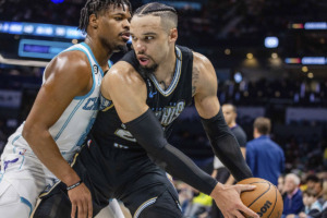 Charlotte Hornets guard Dennis Smith Jr. leans on Memphis Grizzlies forward Dillon Brooks during the first half of an NBA basketball game on Wednesday, Jan. 4, 2023, in Charlotte, N.C. (AP Photo/Scott Kinser)