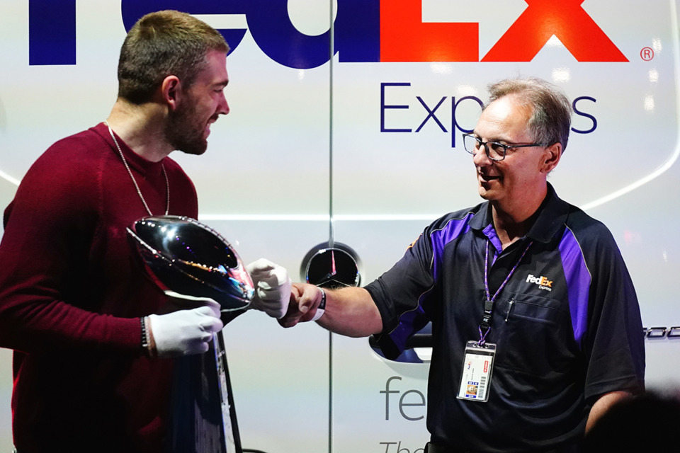 <strong>Arizona Cardinals tight end Zach Ertz (left) gives FedEx delivery driver,&nbsp;David Hokin, a fist bump after the Vince Lombardi Trophy was delivered to the Super Bowl Experience, open to fans for the first day, leading up to the NFL Super Bowl LVII football game in Phoenix, Saturday, Feb. 4, 2023.</strong> (Ross D. Franklin/AP Photo)