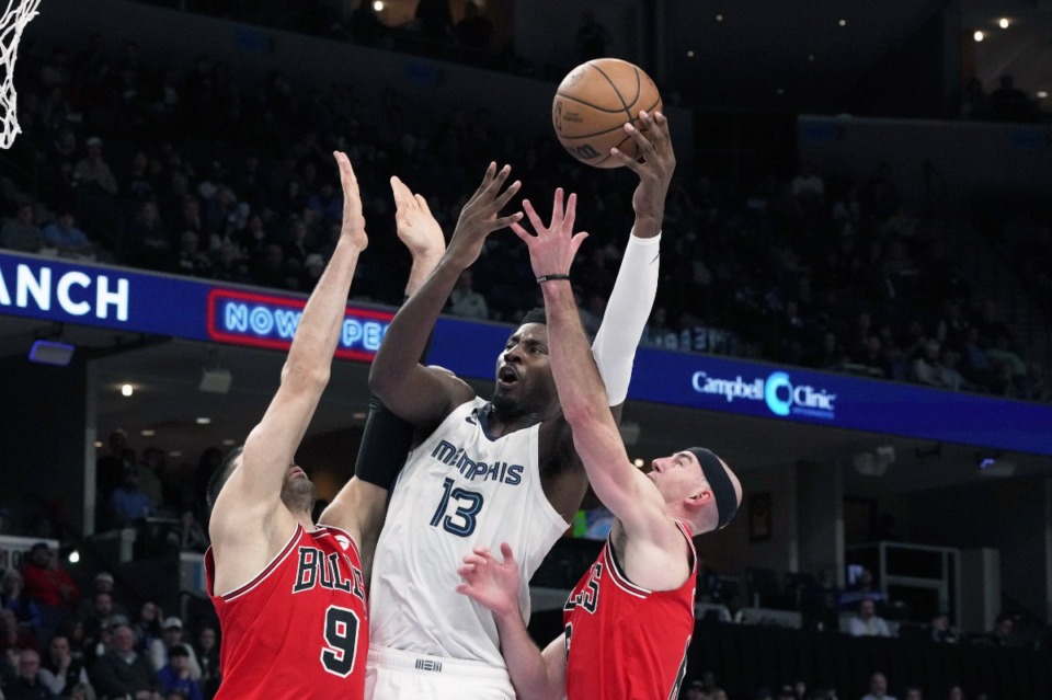 <strong>Memphis Grizzlies' Jaren Jackson Jr. (13) shoots as Chicago Bulls' Nikola Vucevic (9) and Alex Caruso defend on Feb. 7, 2023. Jackson finished with 24 points, three rebounds, five blocks and two steals.</strong>&nbsp;(Karen Pulfer Focht/AP)