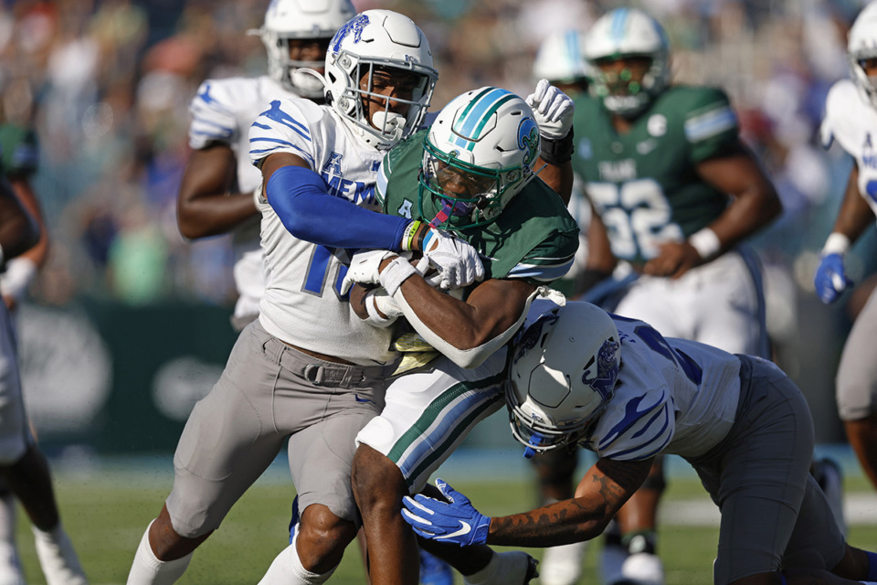 <strong>Tulane running back Shaadie Clayton (0) is tackled by Memphis defensive backs Quindell Johnson (15) and Ladarian Paulk (23) during the first half of an NCAA college football in New Orleans on Oct. 22, 2022.</strong> (Tyler Kaufman/AP Photo)