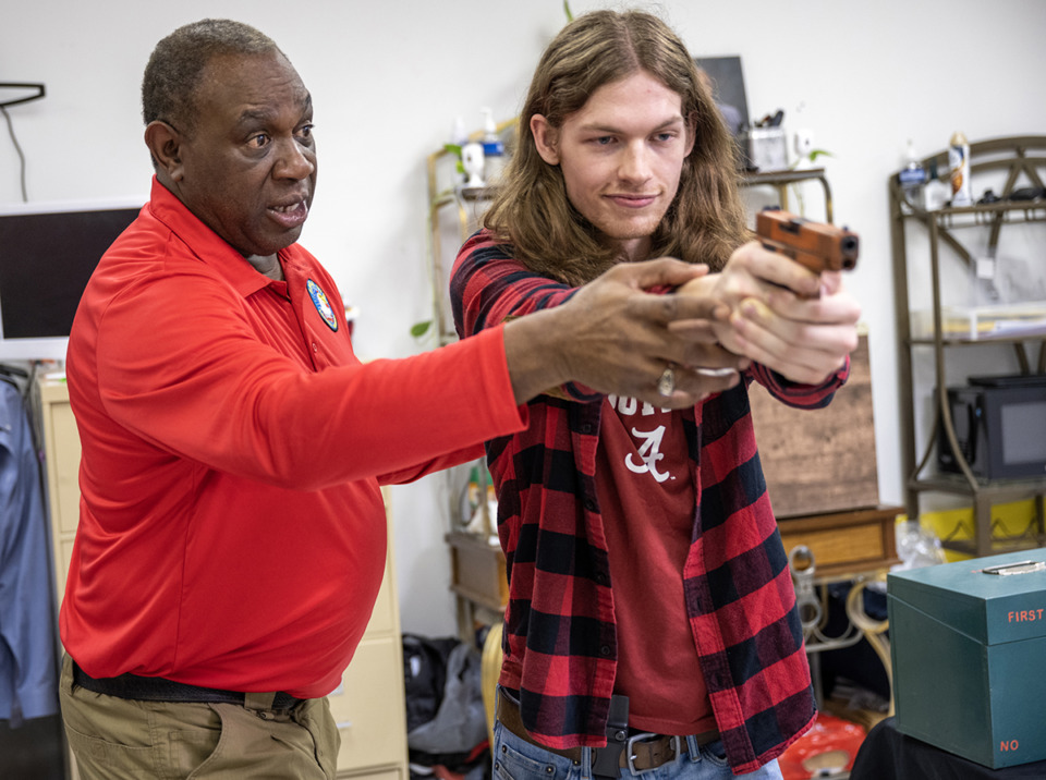<strong>Bennie Cobb instructs Jace Jones on the correct way to stand and hold a gun when defending himself. Cobb is a former Shelby County Sherrif&rsquo;s Office captain and SWAT team commander. Now, he puts an emphasis on gun responsibility at his self-defense class.</strong> (Greg Campbell/Special to The Daily Memphian)