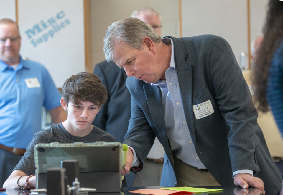 <strong>Arlington High School freshman Coleman Brandt discusses his school project in STEM class with Phillip Ward during the&nbsp;inaugural Mid-South Business Listening Tour on Monday, May 6. Ward is senior director of manufacturing at Wright Medical.</strong> (Greg Campbell/Special to the Daily Memphian)