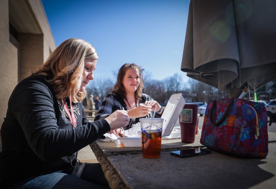 <strong>West Collierville Middle School teachers Crystal Moody (left) and Megan Scales enjoy a lunch from the Soul Fish food truck on Feb. 10, 2023.</strong> (Patrick Lantrip/The Daily Memphian)